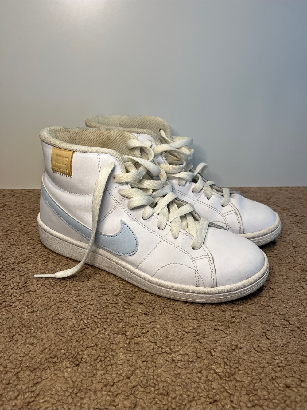 Nike White High-Top Sneakers with Light Blue Swoosh and Tan Patch